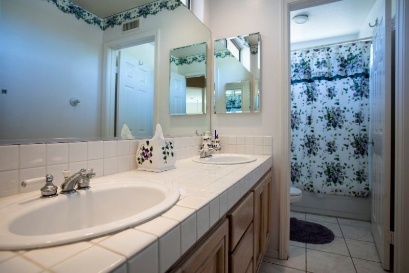 2 white bathroom sink with a large front mirror