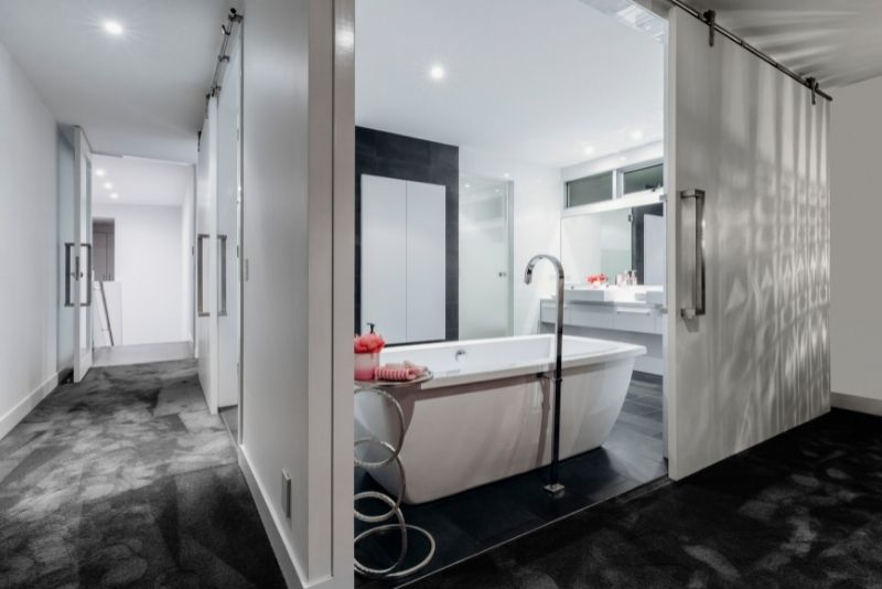 huge white bathtub at the center of the bathroom