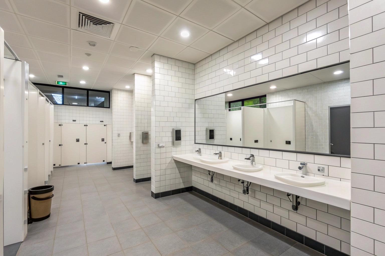 Modern commercial bathroom renovation with sensor taps and non-slip flooring Lake Macquarie
