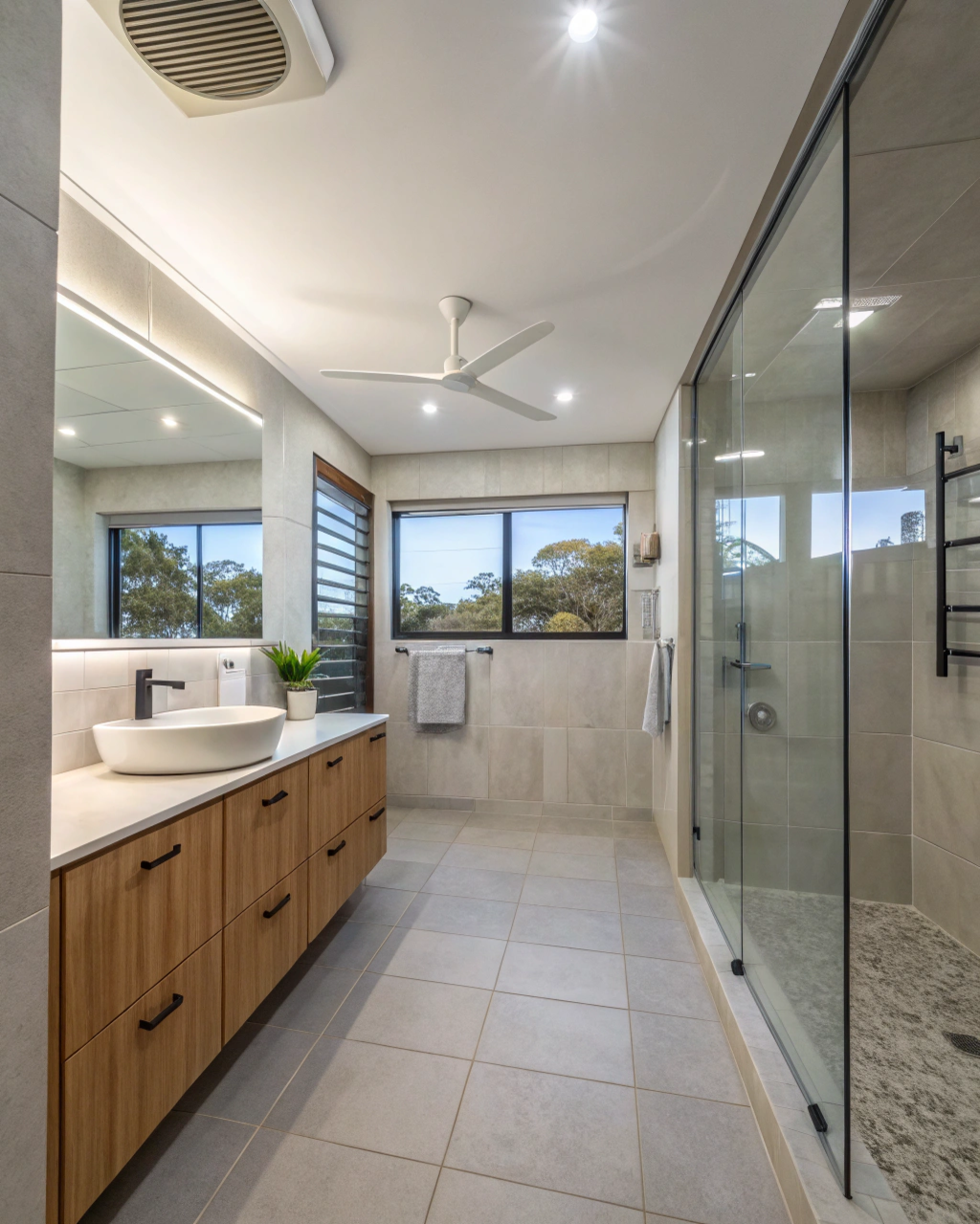 Wide shot of a well-ventilated, fully renovated modern bathroom
